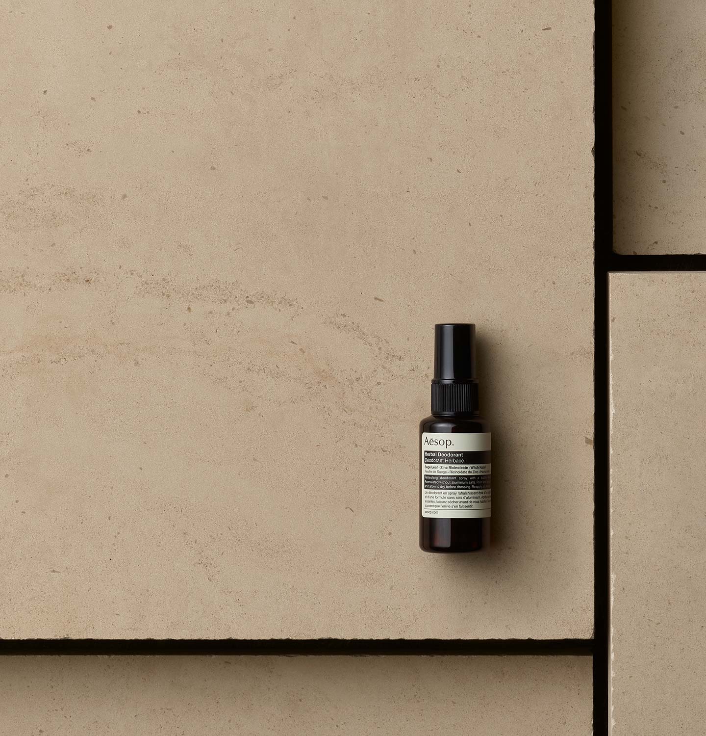 50ml Aesop Deodorant spray bottle on a floor tile