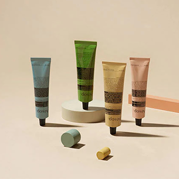 Four tubes of Aesop products displayed with cylinder blocks