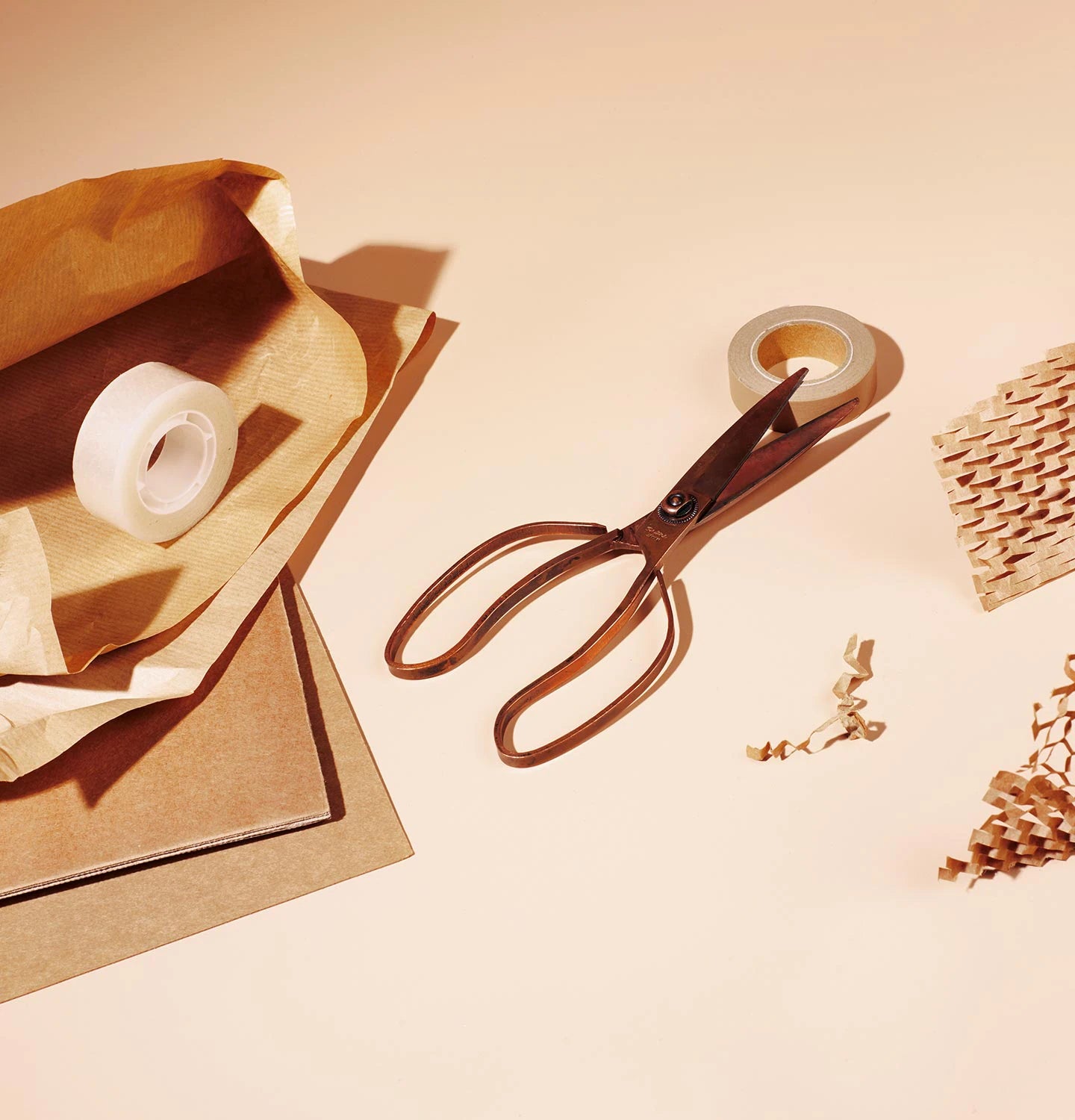 A pair of scissors and tape on packing paper