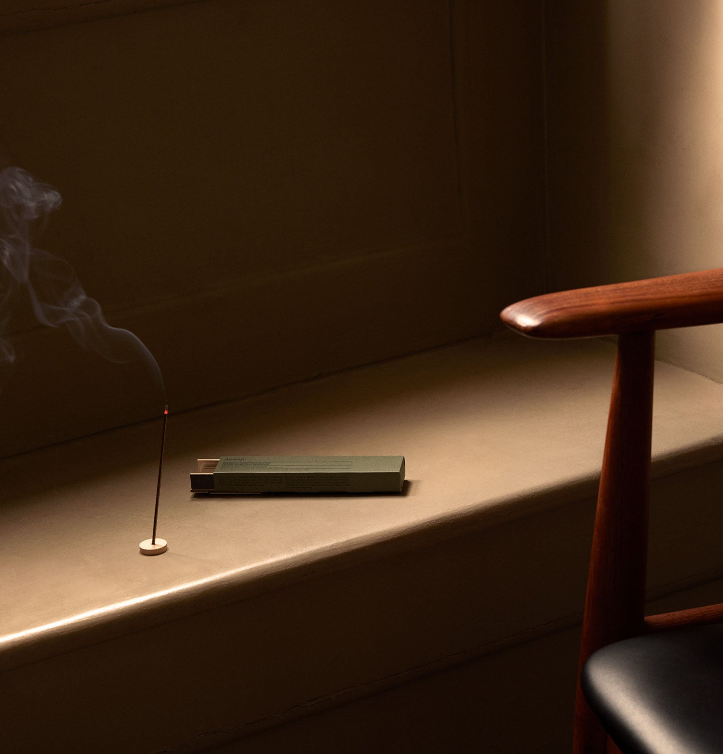 Aesop Sarashina Aromatique Incense burning on a ledge